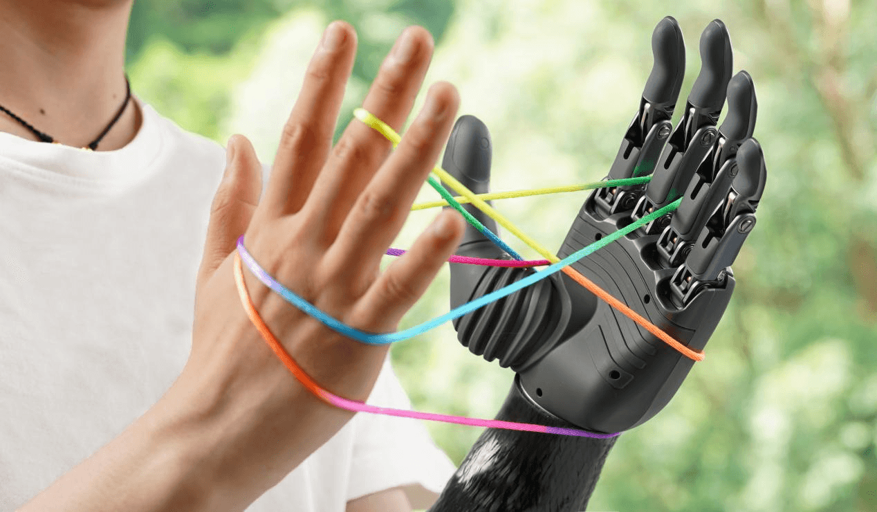 A human hand and a BrainCo bionic hand collaboratively play a cat's cradle game with a colorful string, symbolizing the seamless collaboration and resonance between human and machine.