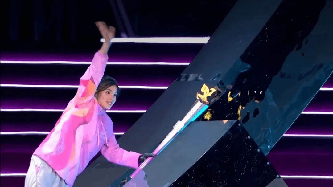 aralympic champion Xu Jialing holding the torch high with her BrainCo bionic hand at the Asian Para Games opening ceremony.